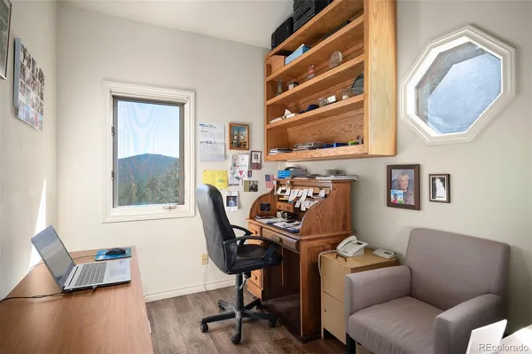 a view of a livingroom with furniture and a window
