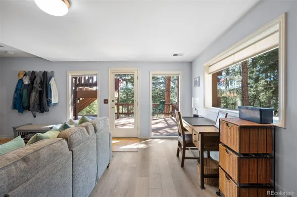a living room with furniture a flat screen tv and a large window