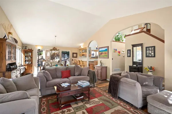 a living room with furniture a rug and a window