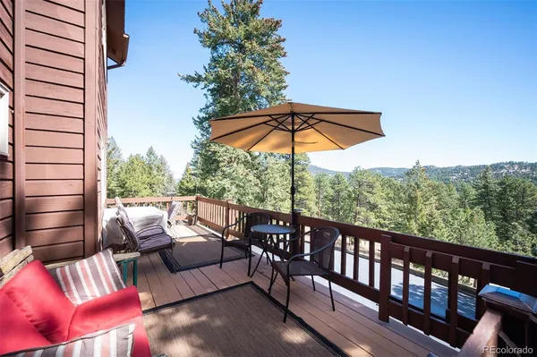 a view of a balcony with couches and wooden floor