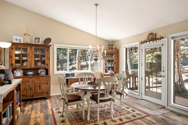 a dining room with furniture and wooden floor