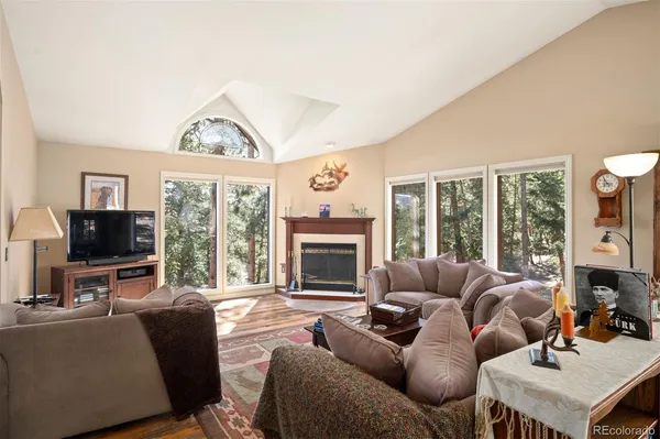 a living room with furniture a large window and a flat screen tv