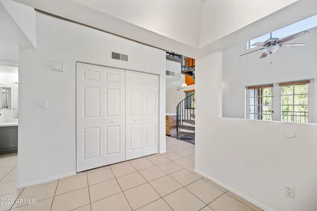 a view of empty room with cabinet and window