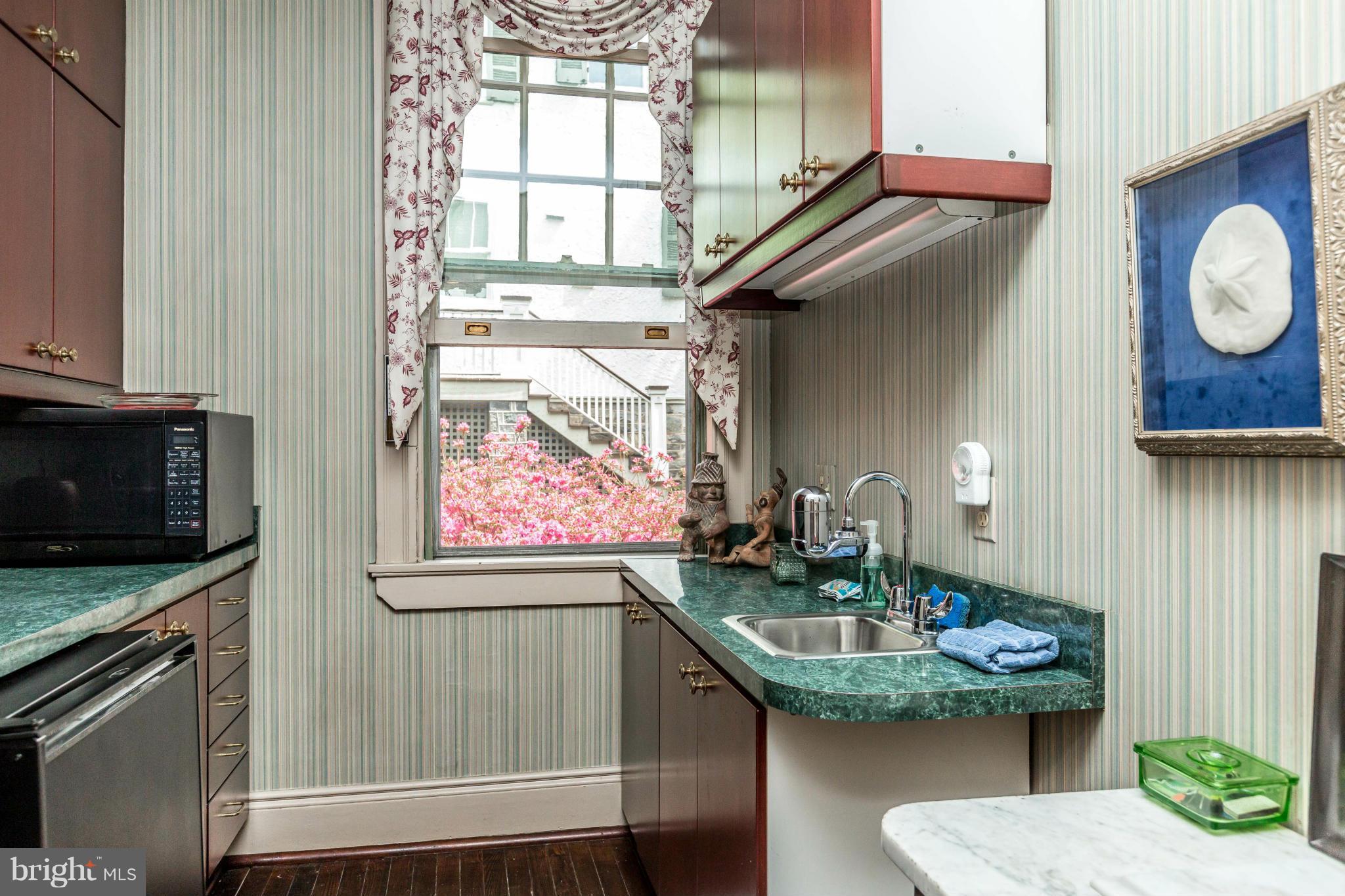 6 Beechdale Road Baltimore, MD 21210 - Photo 14 of 30 a bathroom with a granite countertop sink a mirror and window
