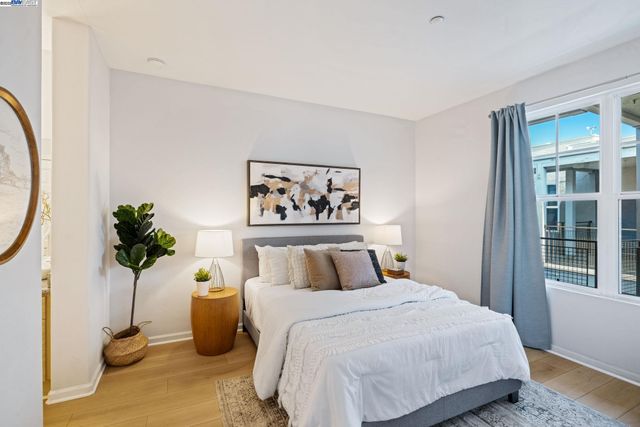 a bedroom with a bed and a painting on the wall