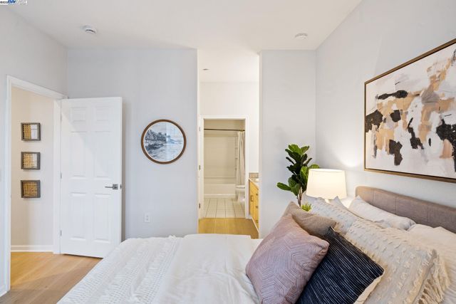 a bedroom with a bed and a wall painting