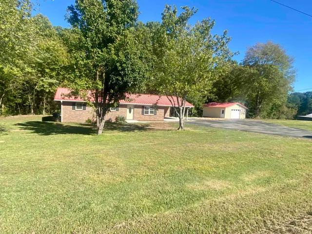 a house view with swimming pool in front of it