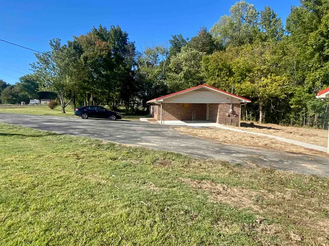 a white house that has a tree in front of it