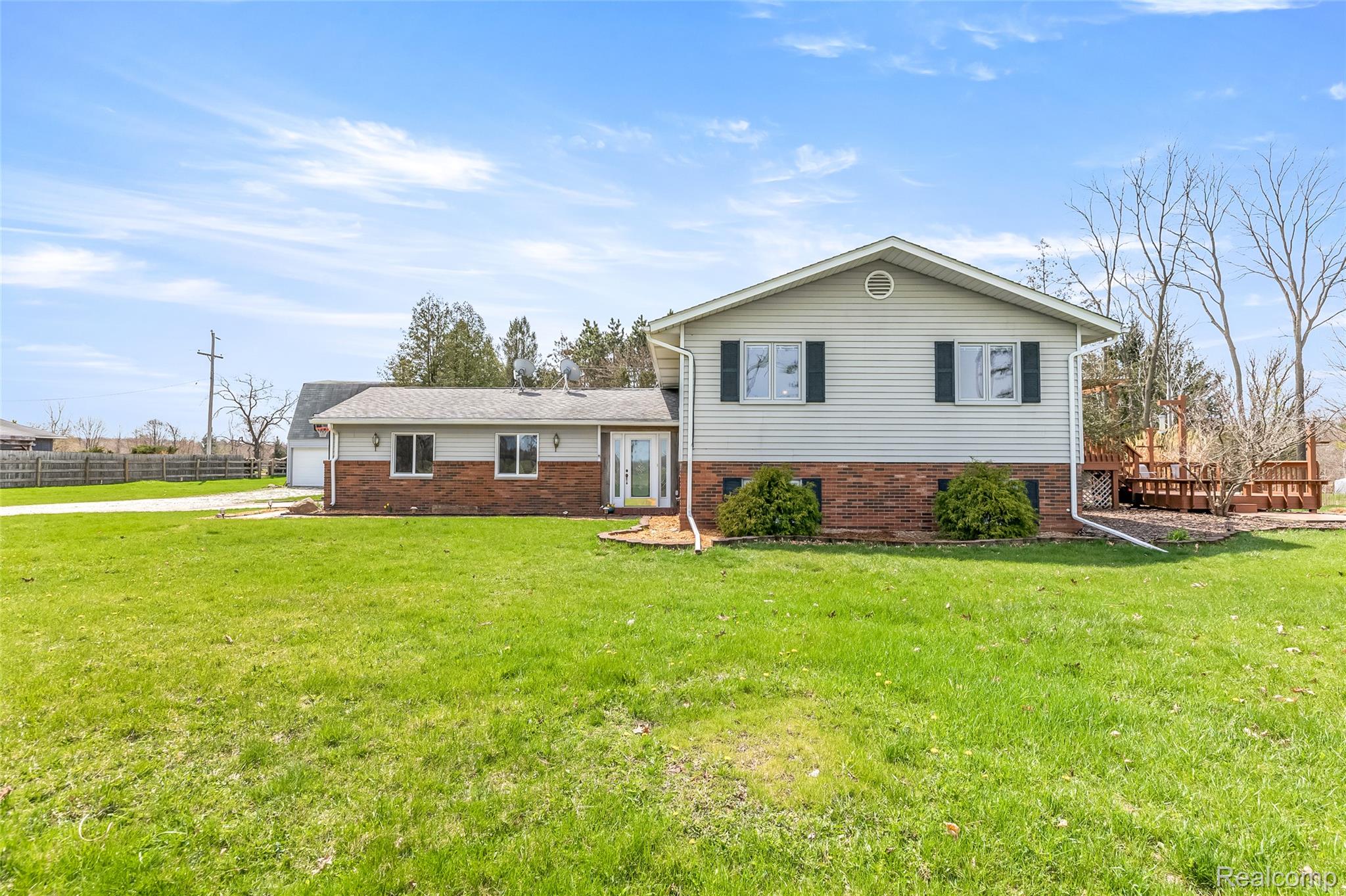 15395 Osius Road Chelsea, MI 48118 - Photo 1 of 55 Split-level residence featuring light-colored siding and a brick-finish foundation