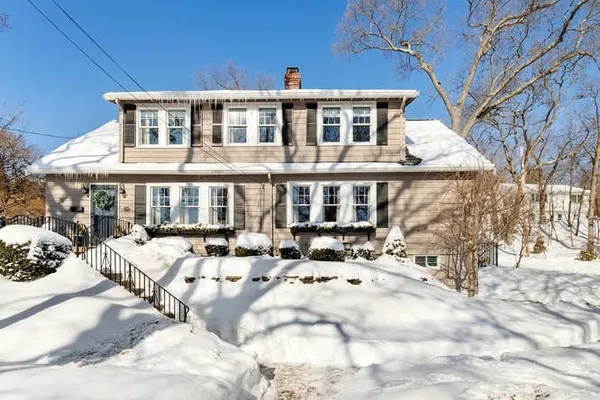 a view of a building with a yard covered in snow