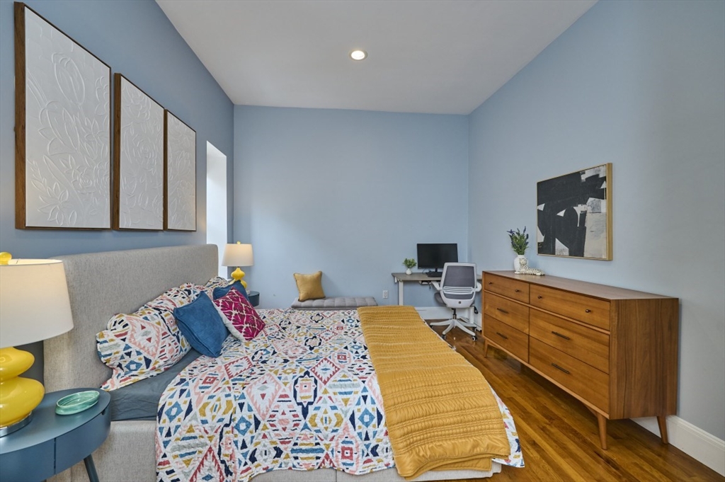 516 Shawmut Avenue, Unit 2 Boston, MA 02118 - Photo 11 of 13 a bedroom with a bed and wooden floor