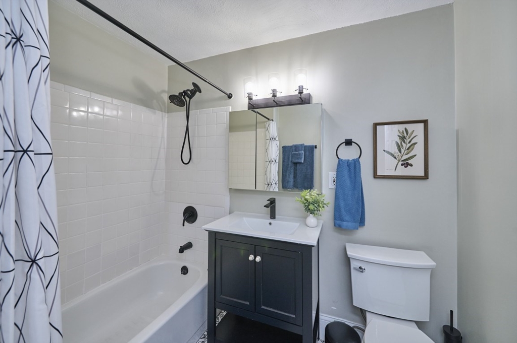 516 Shawmut Avenue, Unit 2 Boston, MA 02118 - Photo 12 of 13 a bathroom with a bathtub shower sink and toilet