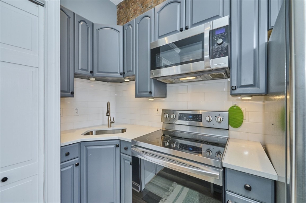 516 Shawmut Avenue, Unit 2 Boston, MA 02118 - Photo 4 of 13 a kitchen with stainless steel appliances a stove and cabinets