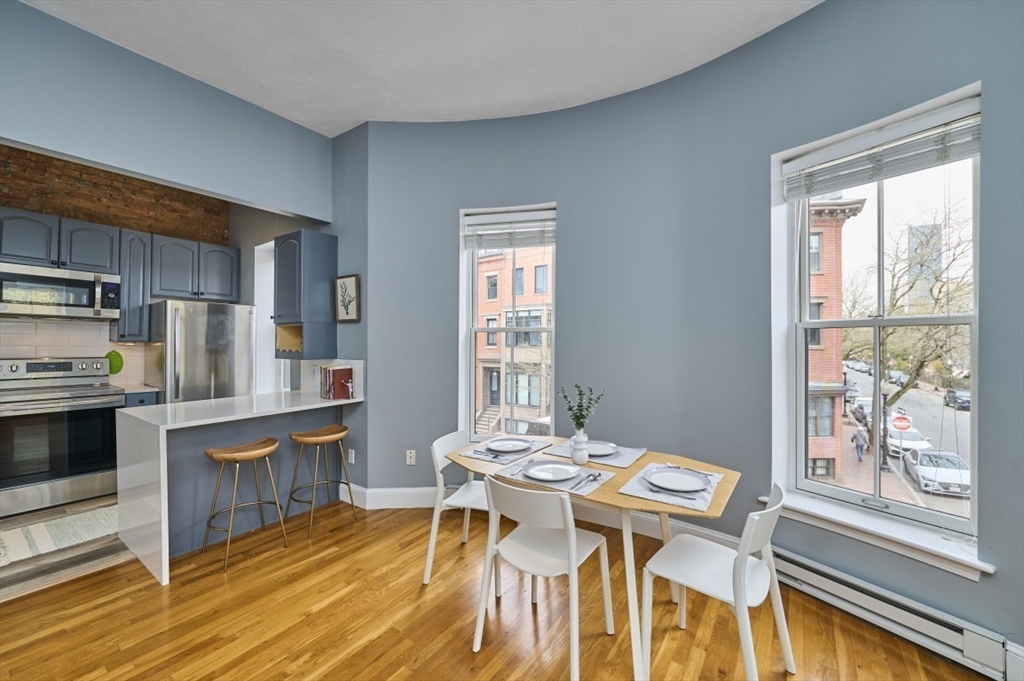 516 Shawmut Avenue, Unit 2 Boston, MA 02118 - Photo 7 of 13 a view of a dining room with furniture window and wooden floor