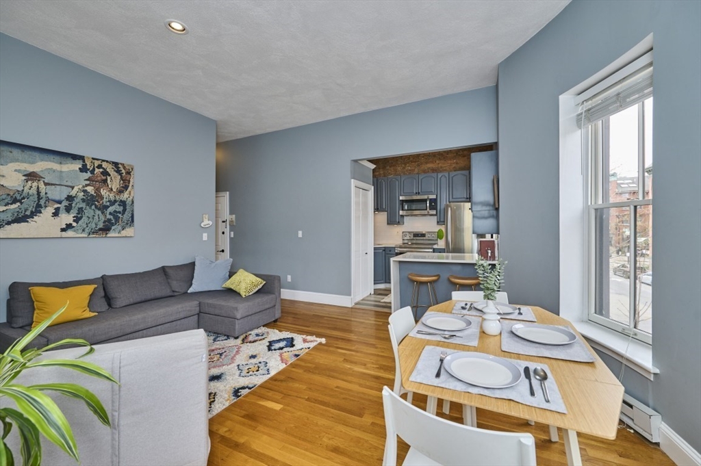 516 Shawmut Avenue, Unit 2 Boston, MA 02118 - Photo 8 of 13 a living room with furniture and a large window