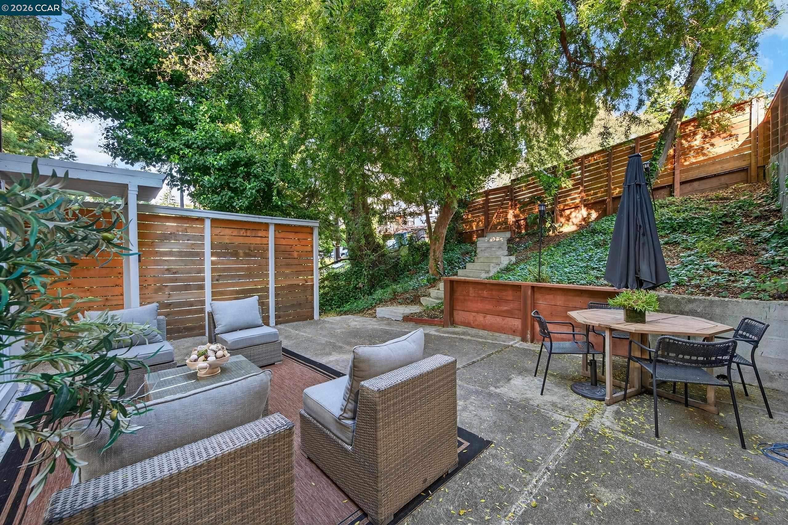 230 Fairlawn Drive Berkeley, CA 94708 - Photo 34 of 58 a view of a patio with couches table and chairs and potted plants