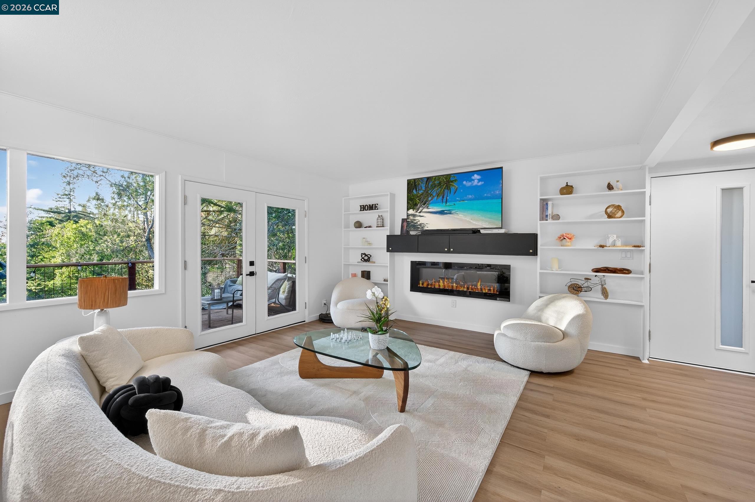 230 Fairlawn Drive Berkeley, CA 94708 - Photo 10 of 58 a living room with furniture a fireplace and a flat screen tv