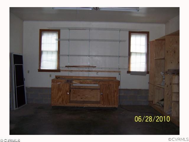 13001 Rivers Bend Road Chester, VA 23836 - Photo 12 of 12 a living room with a stove and a window