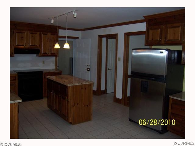 13001 Rivers Bend Road Chester, VA 23836 - Photo 9 of 12 a kitchen with refrigerator and mirror