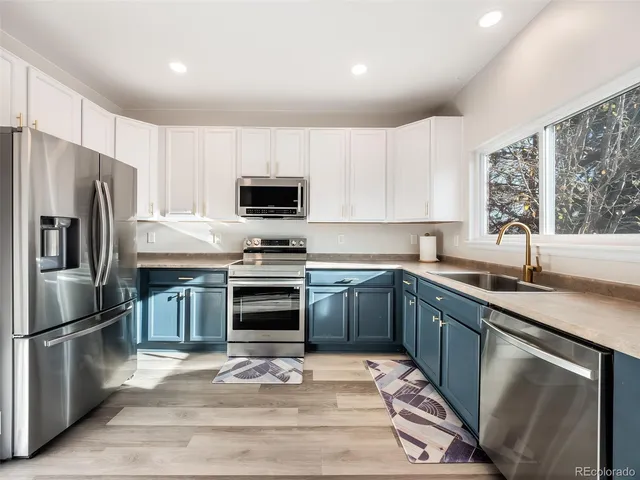 a kitchen with a sink stove and refrigerator