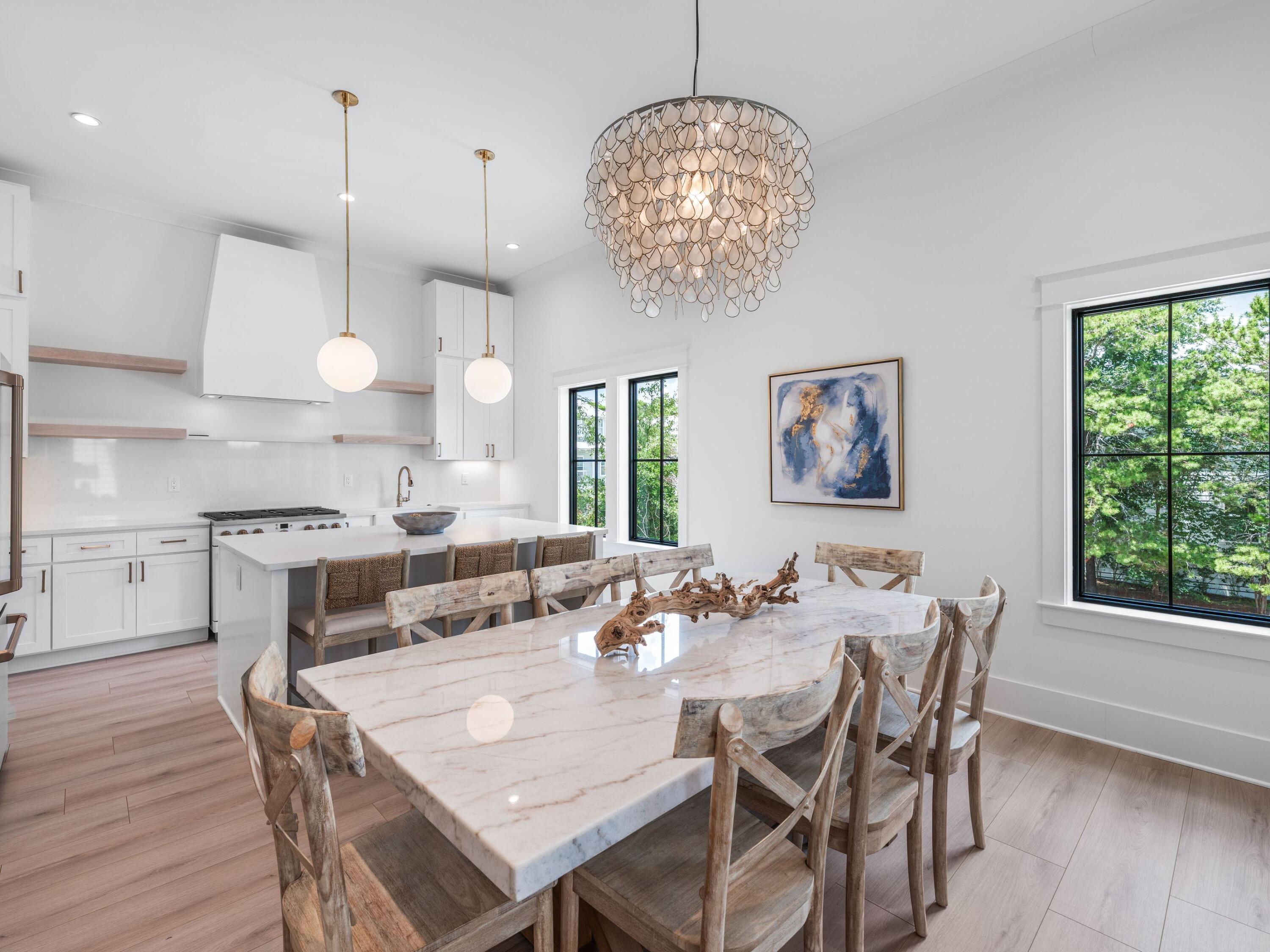 394 Grande Pointe Cir Inlet Beach Inlet Beach, FL 32461 - Photo 14 of 54 a view of a dining room with furniture wooden floor and chandelier