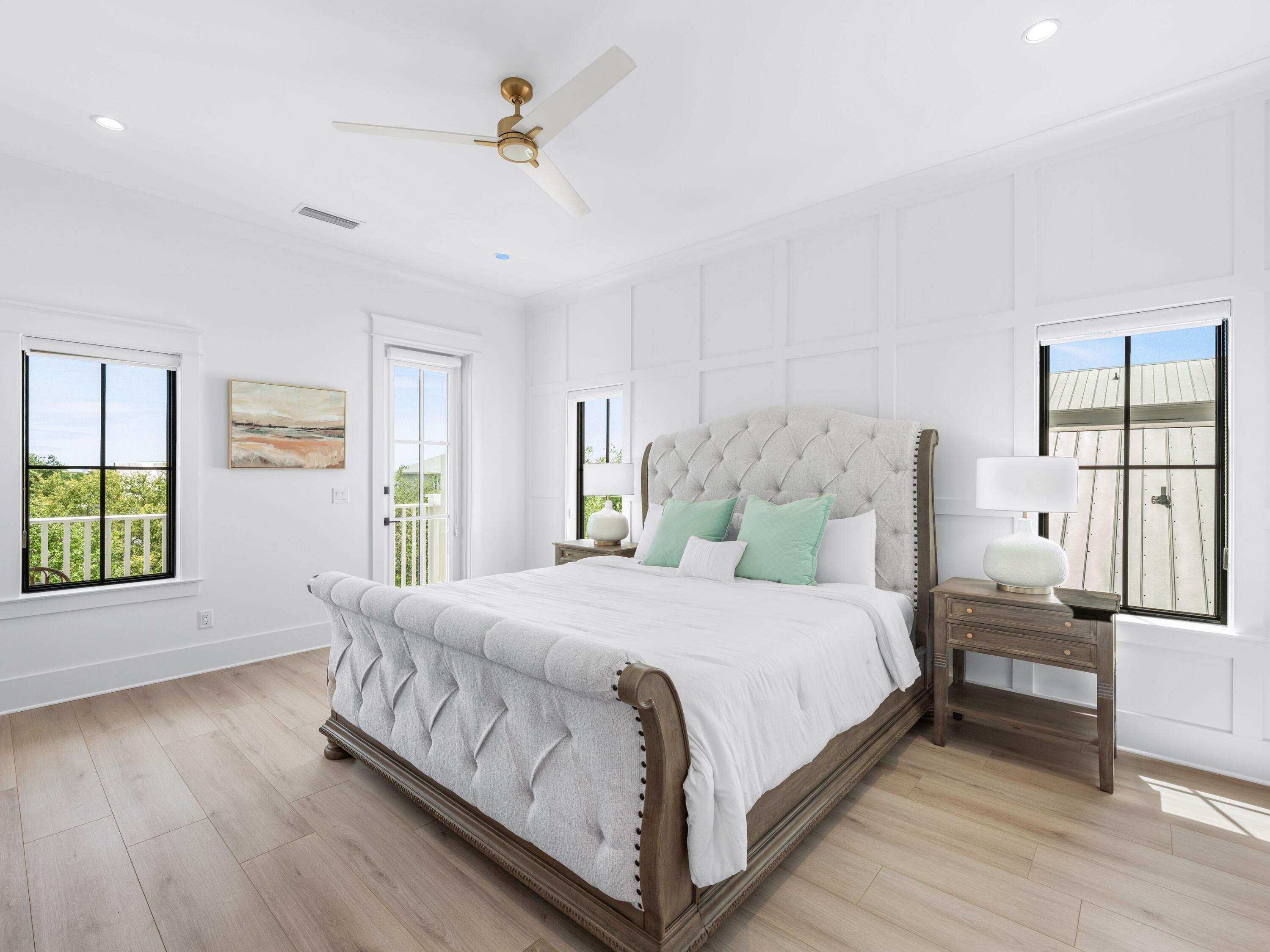 394 Grande Pointe Cir Inlet Beach Inlet Beach, FL 32461 - Photo 22 of 54 a bedroom with a large bed wooden floor and window