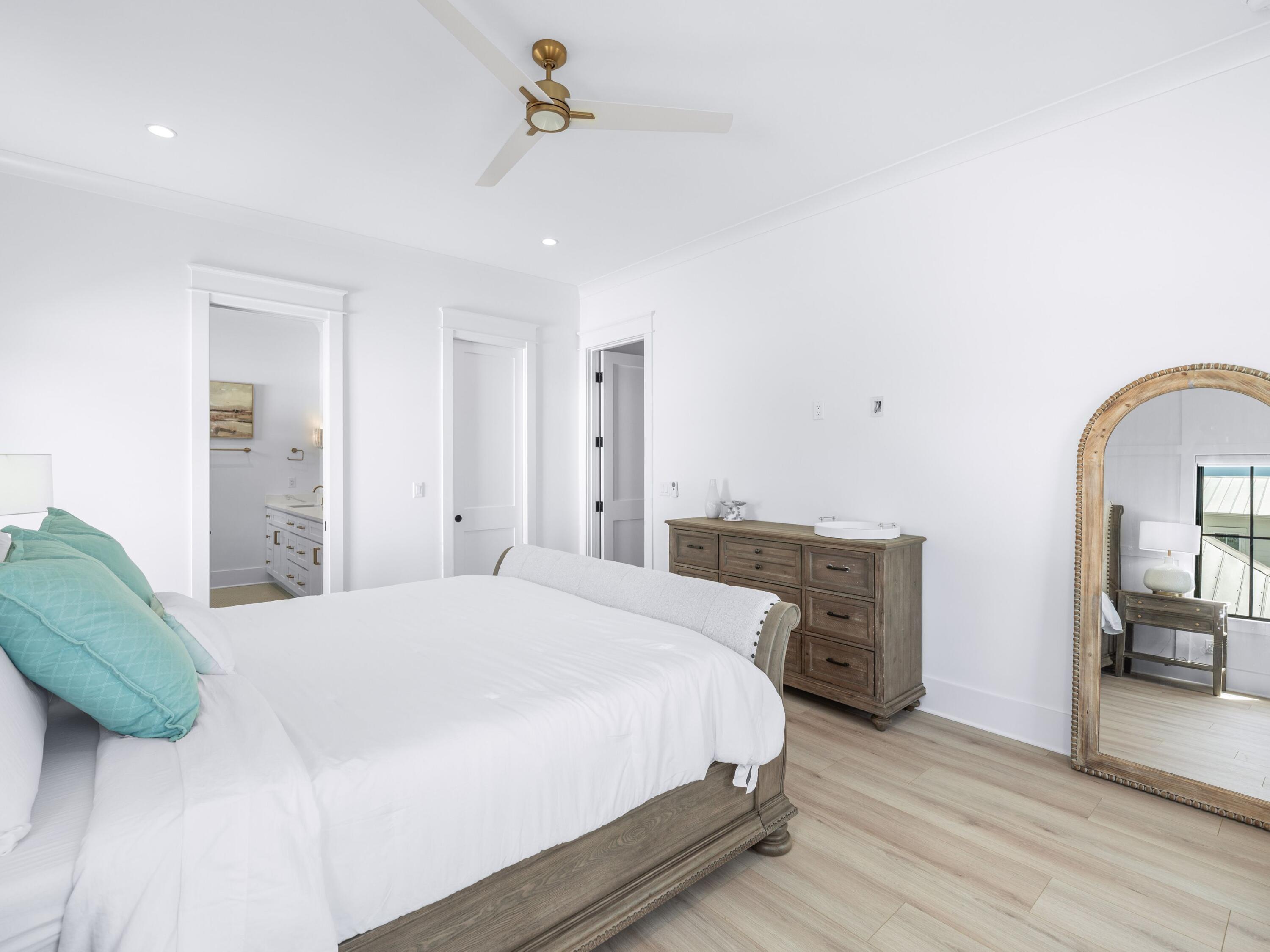 394 Grande Pointe Cir Inlet Beach Inlet Beach, FL 32461 - Photo 23 of 54 a bedroom with a bed and a chandelier
