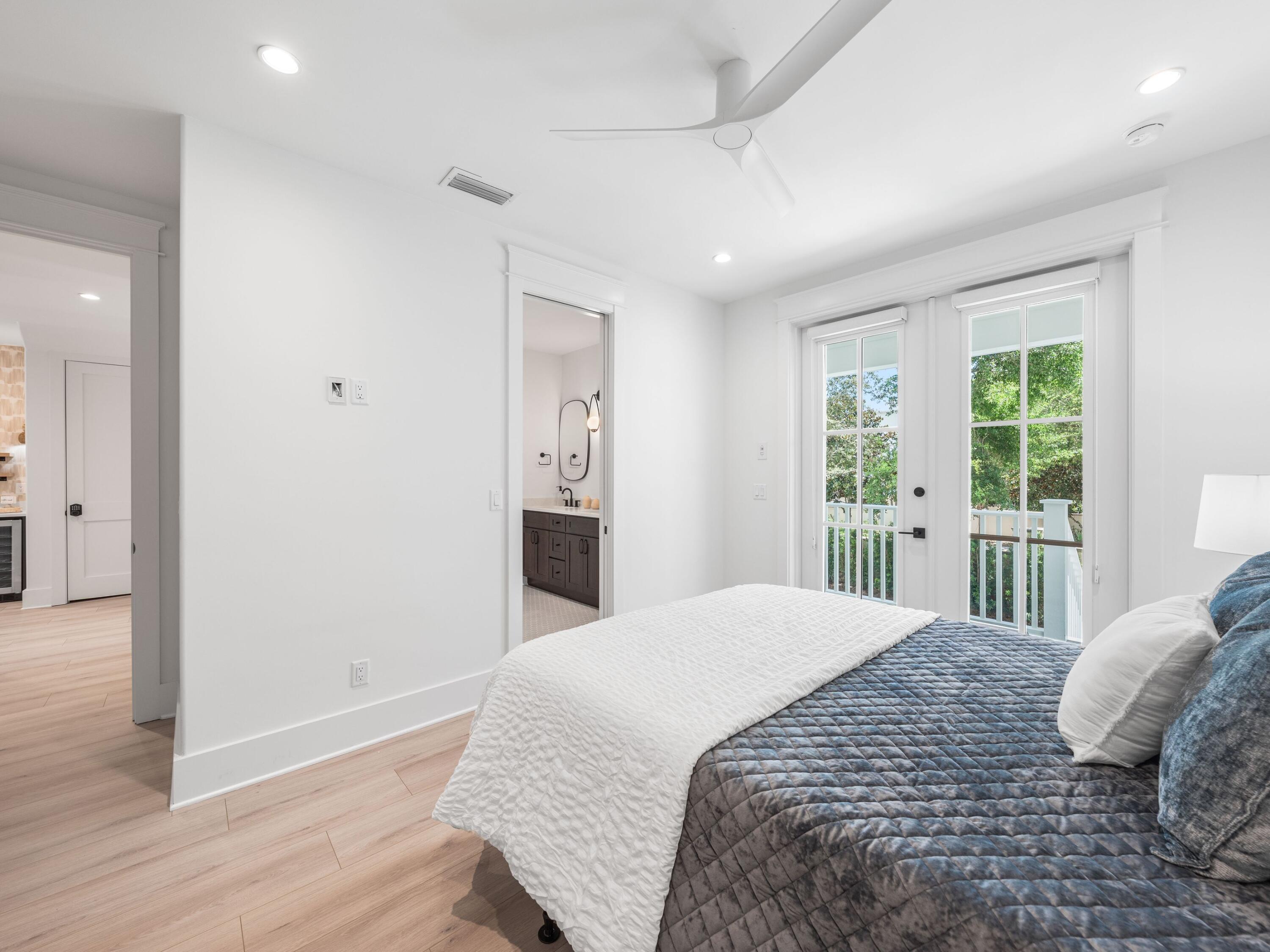 394 Grande Pointe Cir Inlet Beach Inlet Beach, FL 32461 - Photo 27 of 54 a bedroom with a large bed and wooden floor