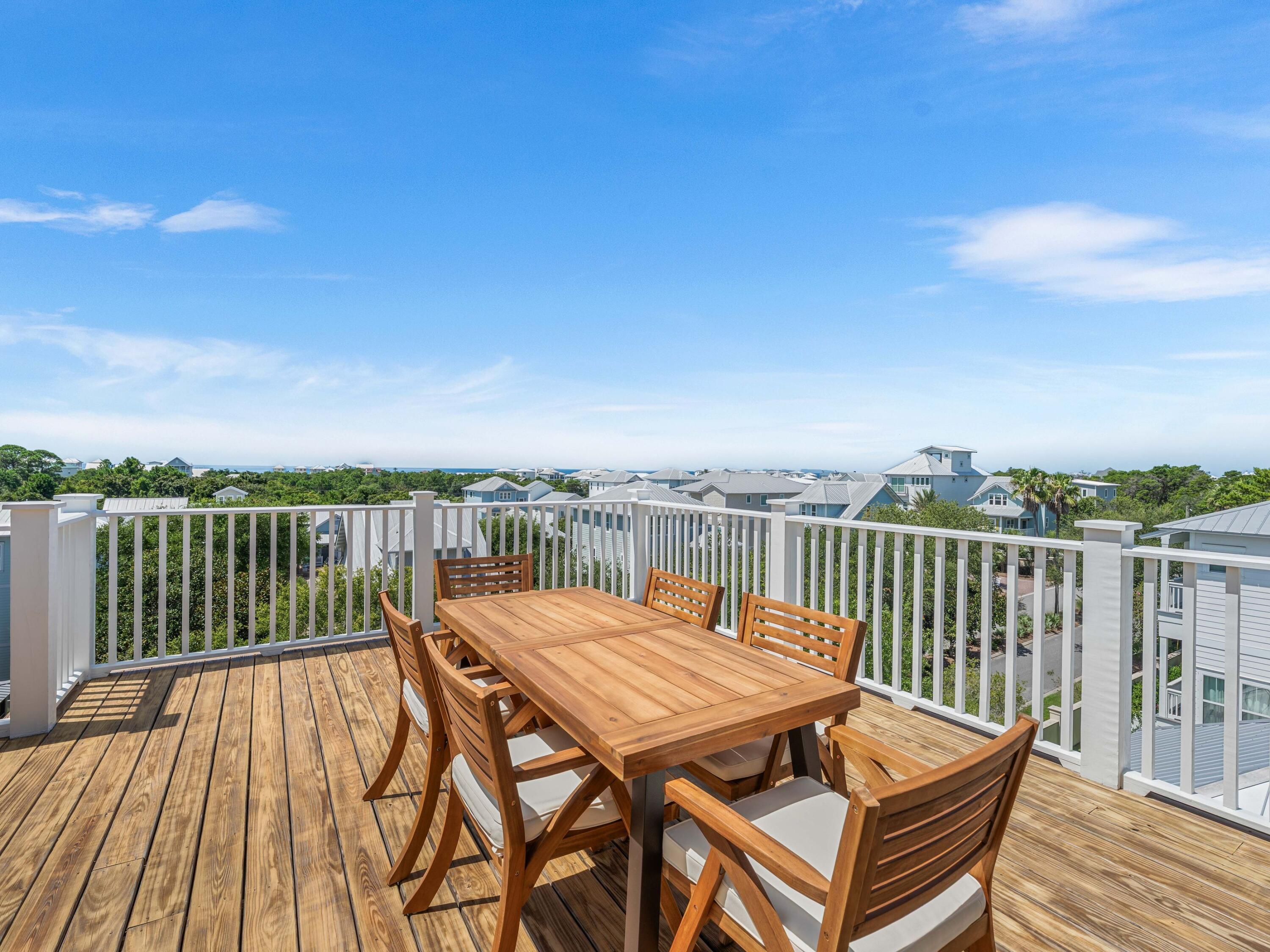 394 Grande Pointe Cir Inlet Beach Inlet Beach, FL 32461 - Photo 49 of 54 a view of a balcony with wooden floor and seating space