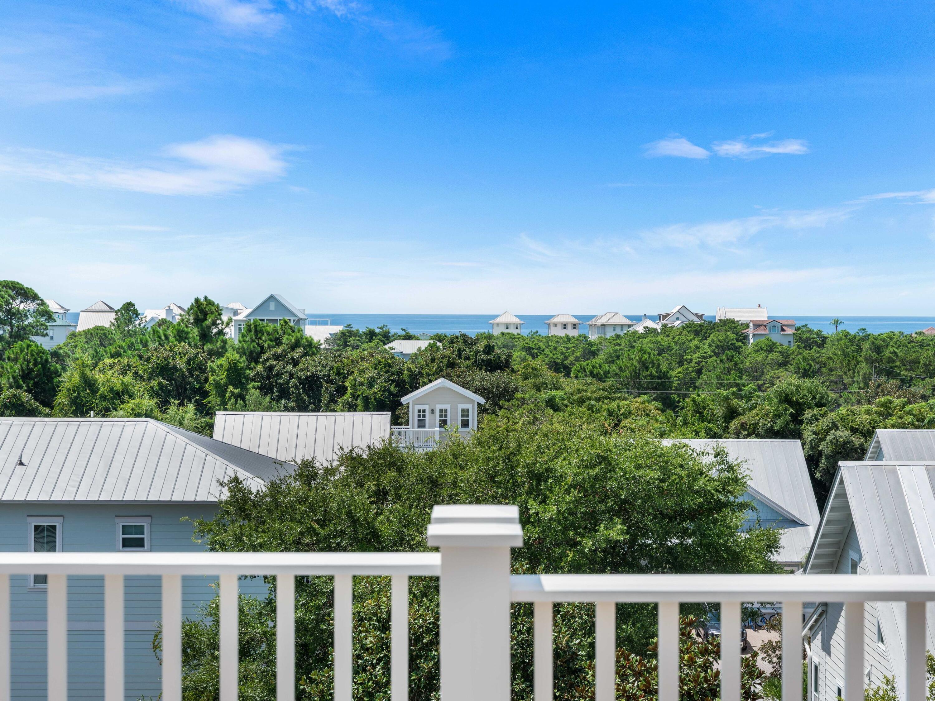 394 Grande Pointe Cir Inlet Beach Inlet Beach, FL 32461 - Photo 5 of 54 a view of a white house with a yard plants and wooden fence