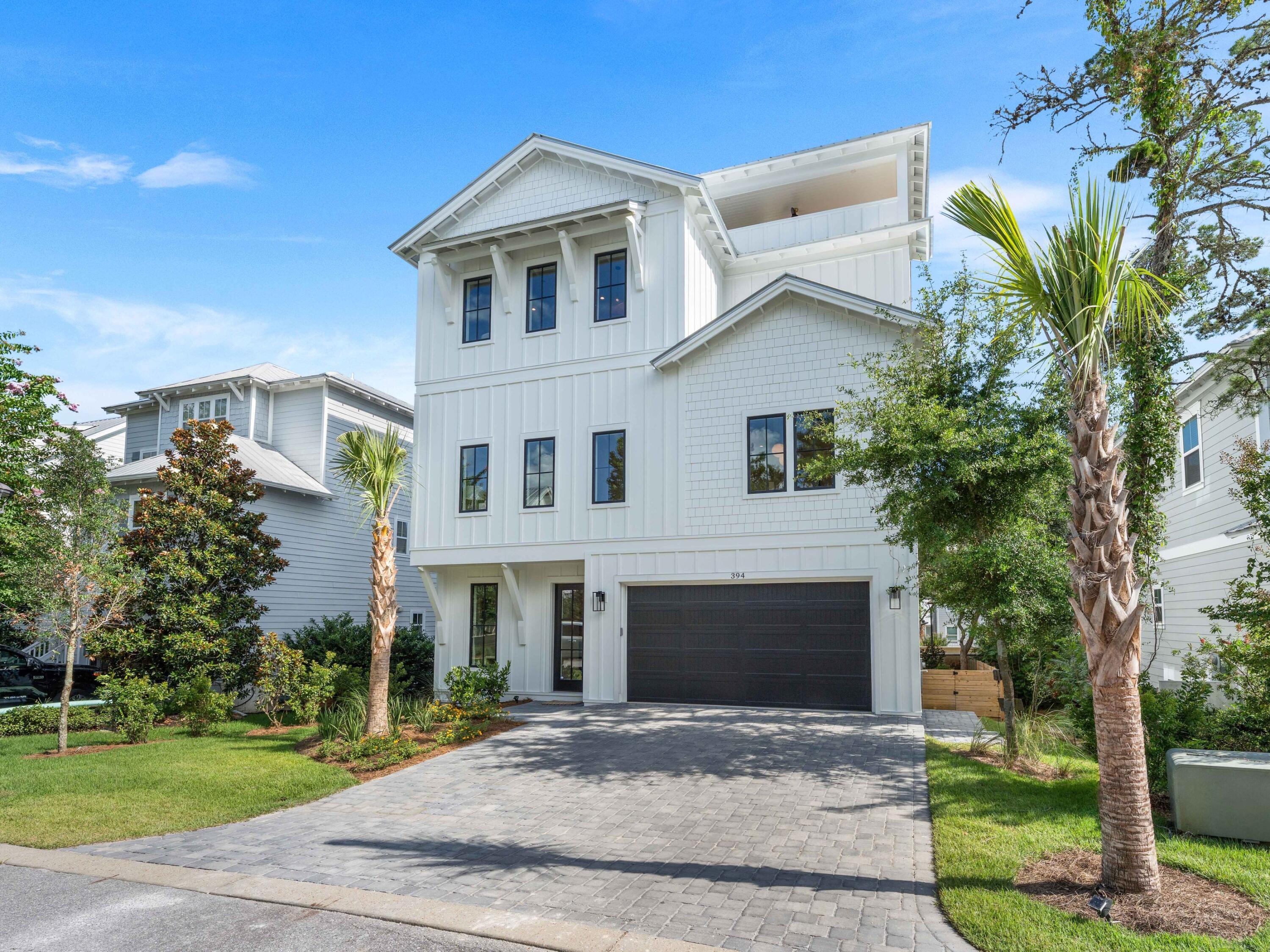 394 Grande Pointe Cir Inlet Beach Inlet Beach, FL 32461 - Photo 6 of 54 a front view of a house with a yard and trees