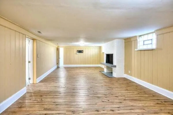 a view of a livingroom with wooden floor and a flat screen tv