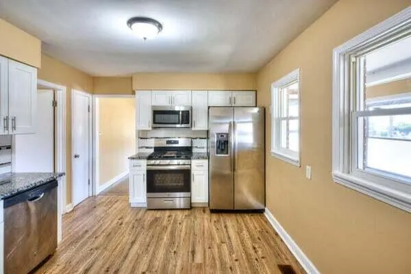 a kitchen with stainless steel appliances a refrigerator and a stove top oven