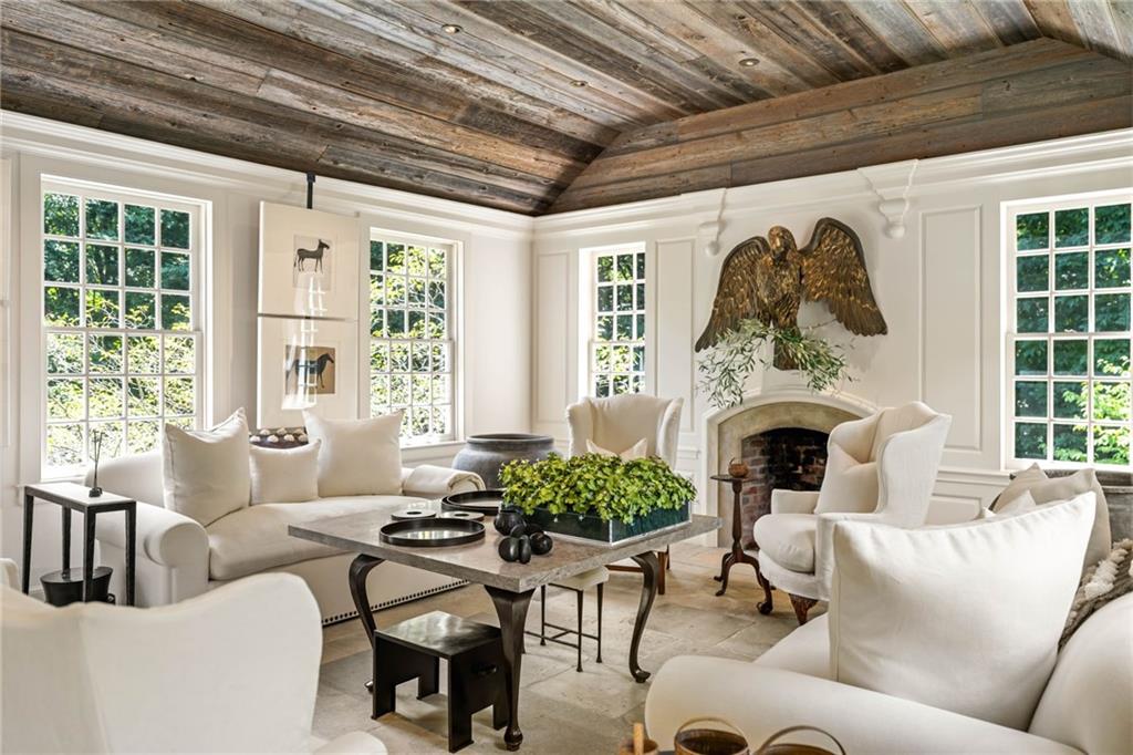 1727 West Paces Ferry Road Northwest Atlanta, GA 30327 - Photo 12 of 26 a living room with furniture a fireplace and a potted plant