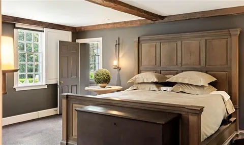 a bedroom with a bed and dresser