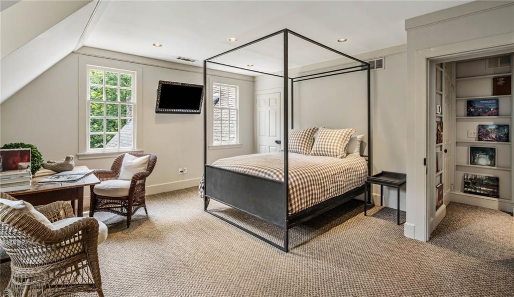 1727 West Paces Ferry Road Northwest Atlanta, GA 30327 - Photo 19 of 26 a bedroom with a bed a chair and a flat screen tv