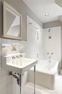 a bedroom with a bed chair and fireplace