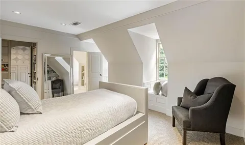 a view of a green field with wooden fence