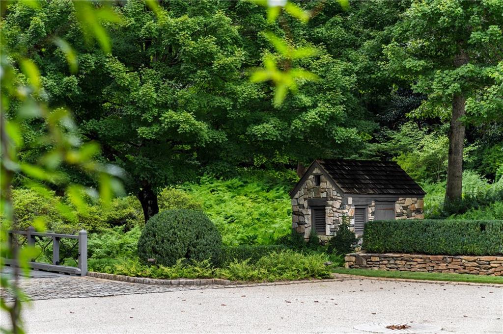 1727 West Paces Ferry Road Northwest Atlanta, GA 30327 - Photo 23 of 26 a front view of a house with a yard