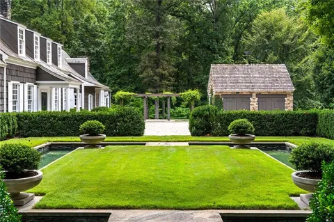 a view of a house with pool and a yard
