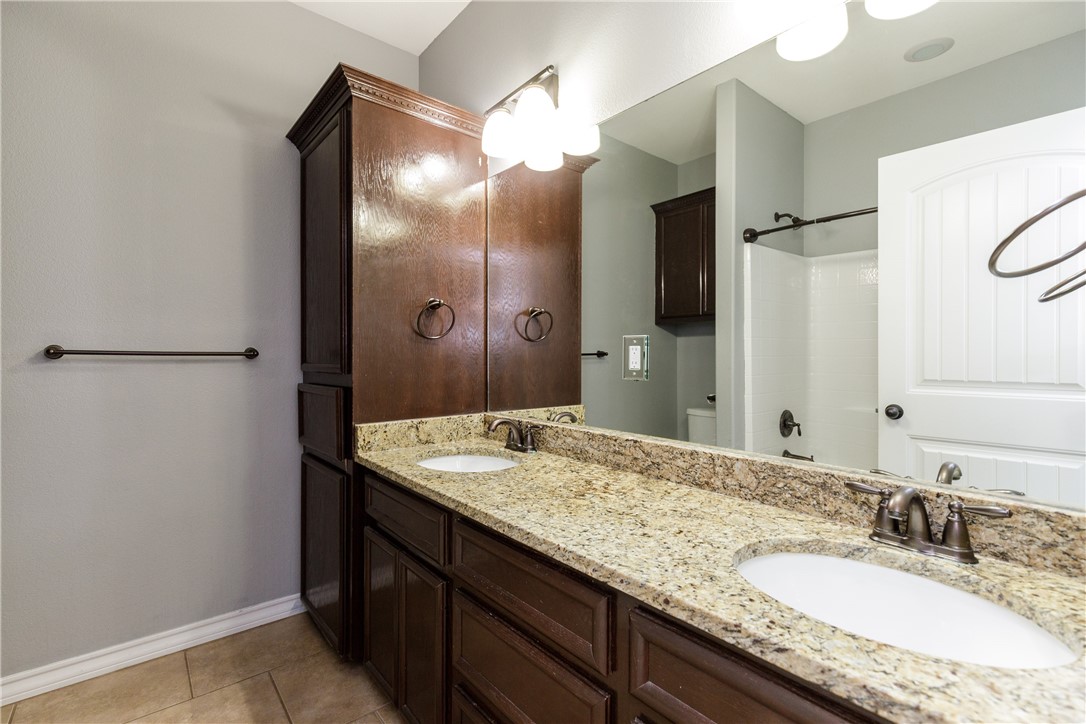 8314 Excalibur Road Corpus Christi, TX 78414 - Photo 12 of 26 a bathroom with a granite countertop sink and a mirror