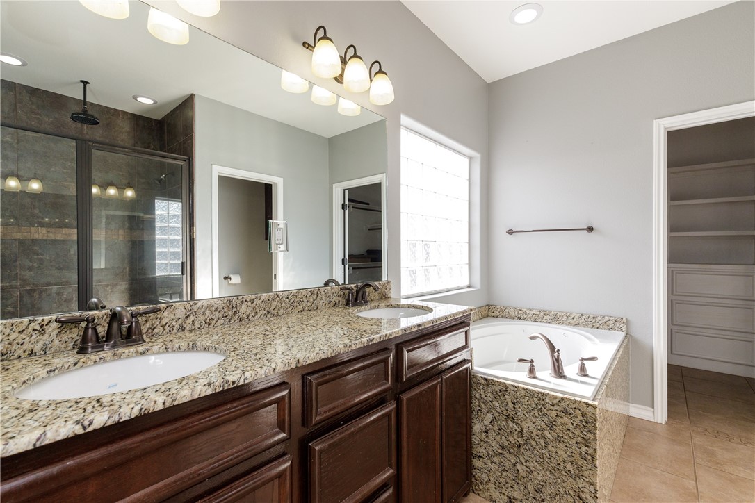 8314 Excalibur Road Corpus Christi, TX 78414 - Photo 19 of 26 a bathroom with a granite countertop sink and a mirror