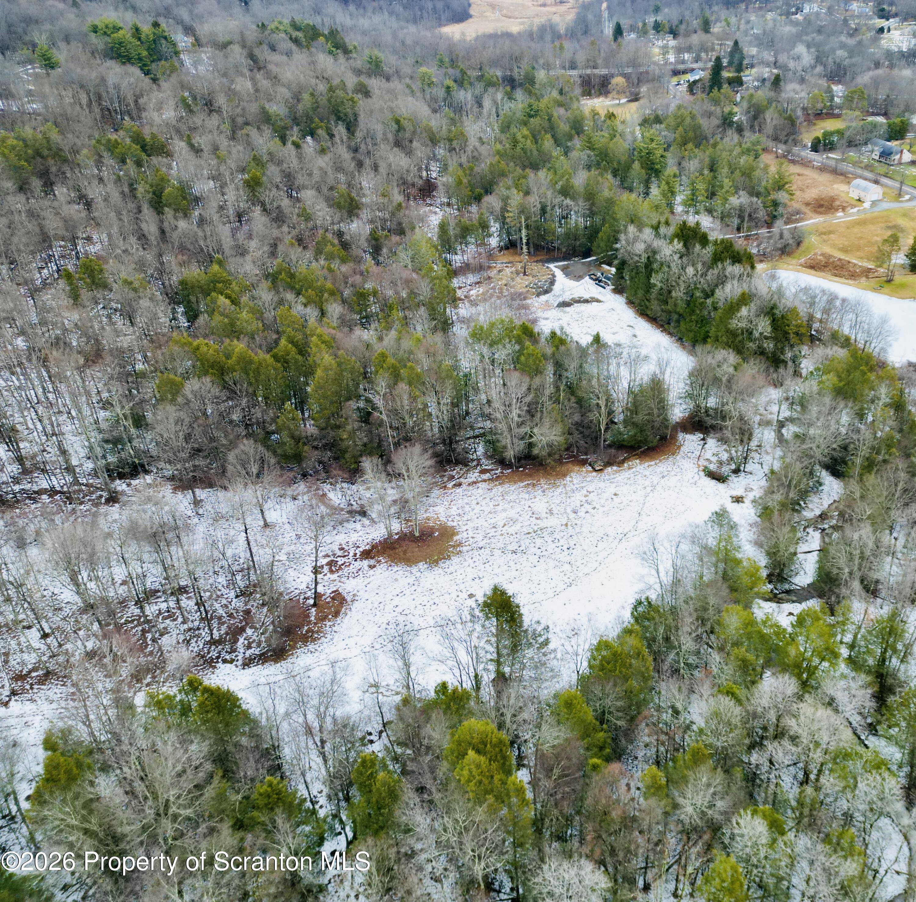 Gravel Pond Road Clarks Summit, PA 18411 - Photo 7 of 14 a view of a forest with a street