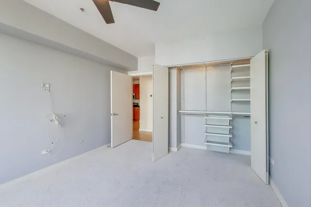 a view of walk in closet with empty racks