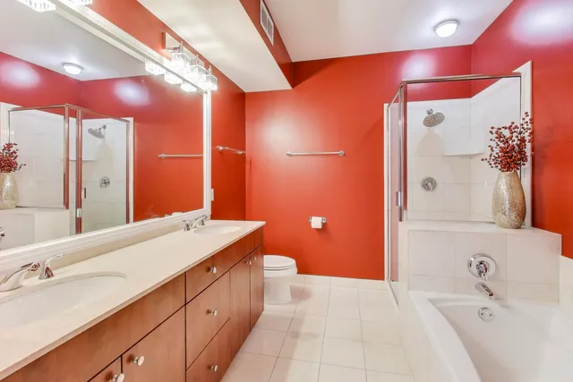 a bathroom with a double vanity sink mirror and shower