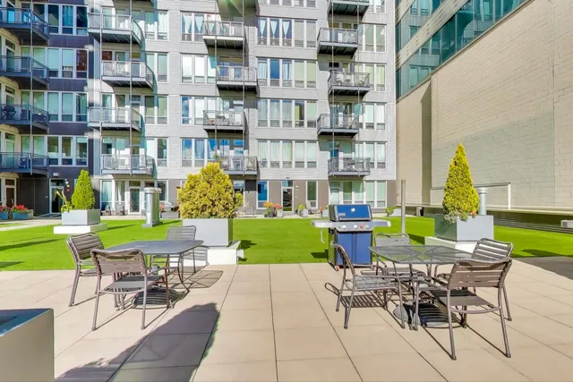 a view of a chairs and table in backyard