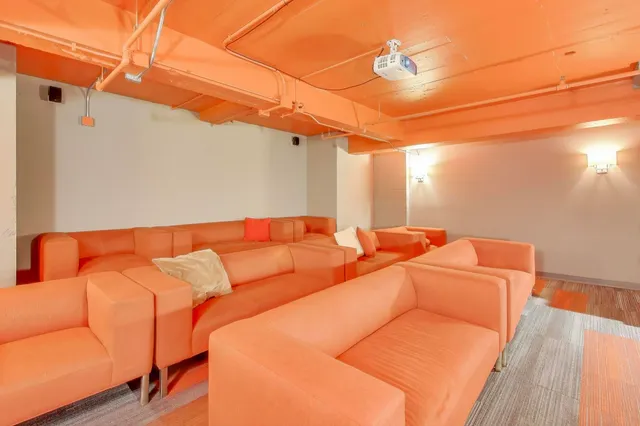 a room with lots of wooden furniture and a stainless steel appliances