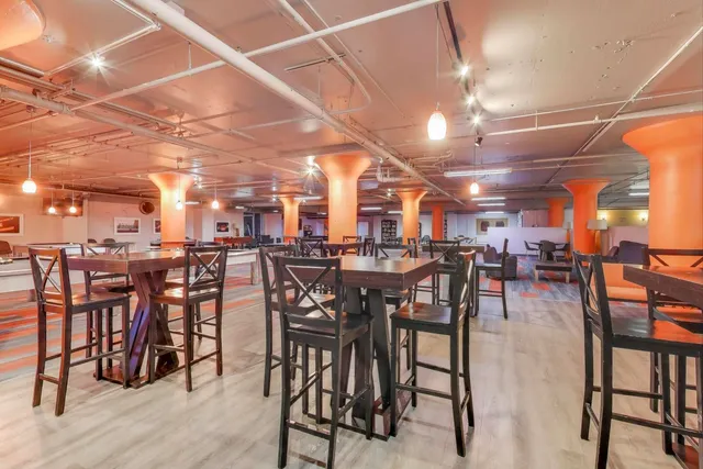 a view of a patio with dining table chairs and wooden floor
