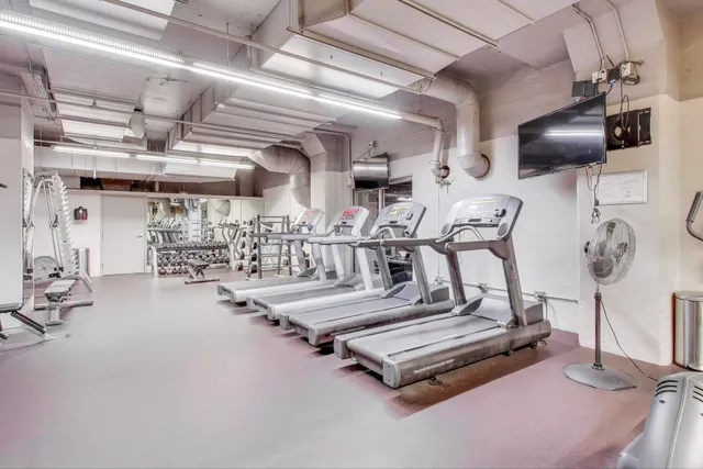 a kitchen with kitchen island a dining table chairs and wooden floors