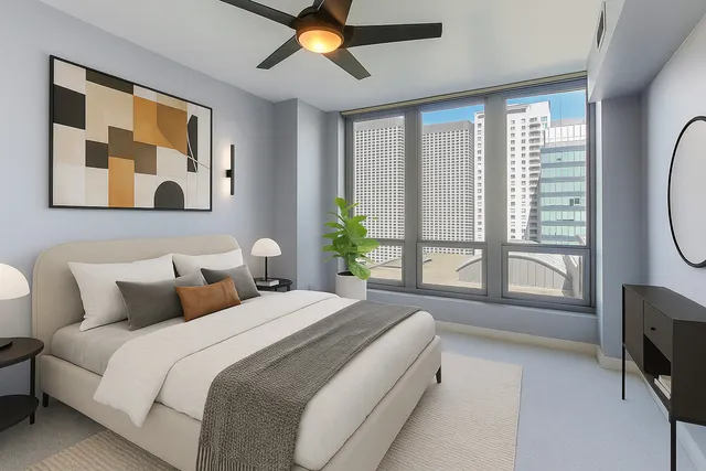 a bedroom with a large bed and a large window